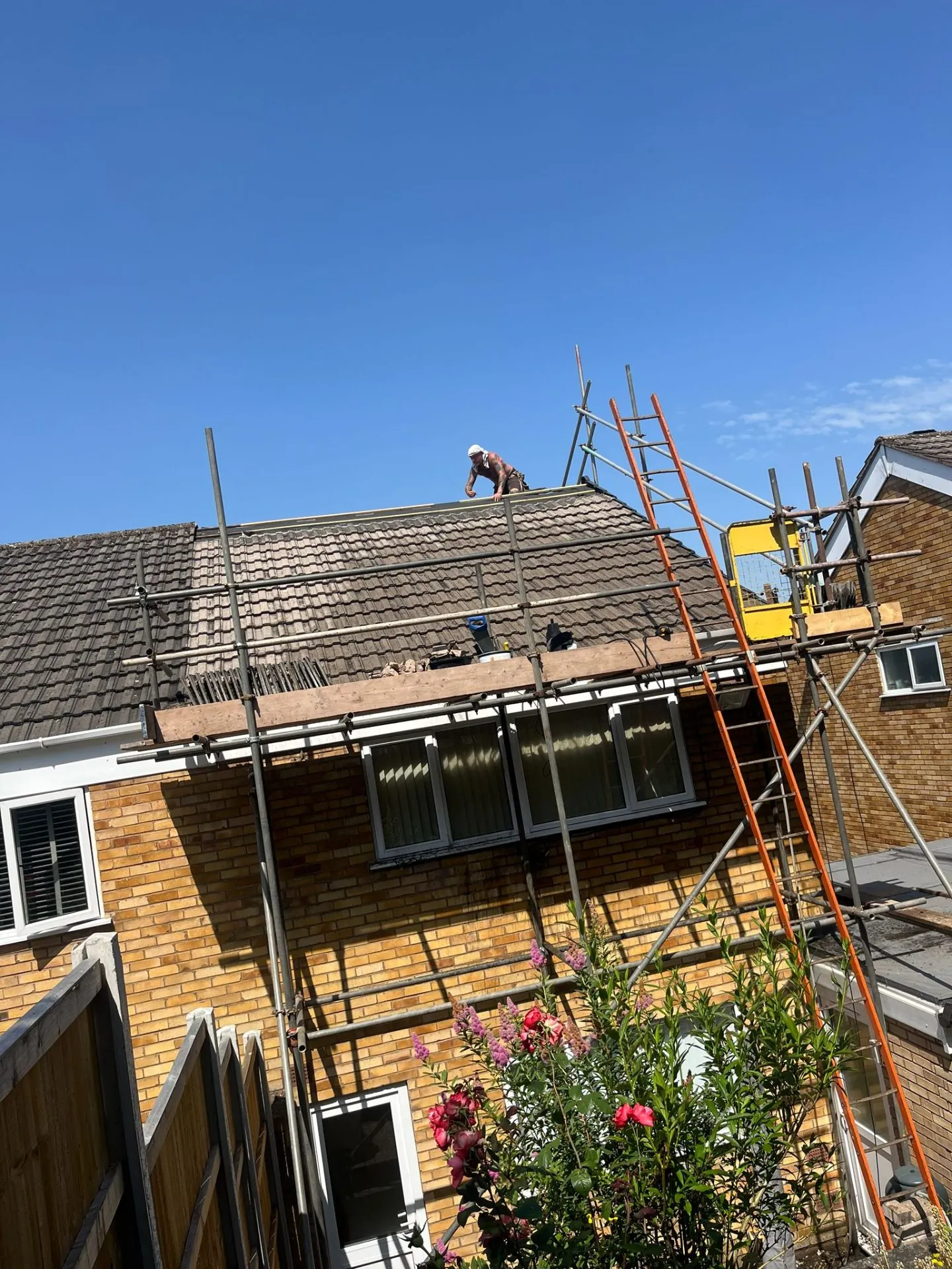 Home Insulation GB team re-roofing a UK property from scaffolding